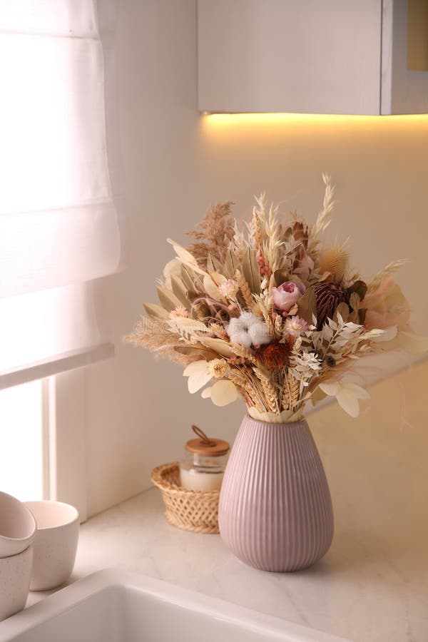 Bouquet of Dry Flowers and Leaves on Countertop in Kitchen Stock Image
