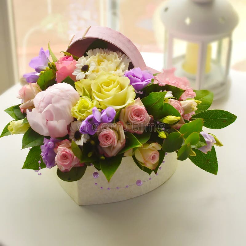 Pink buquet of gentle flowers in a box