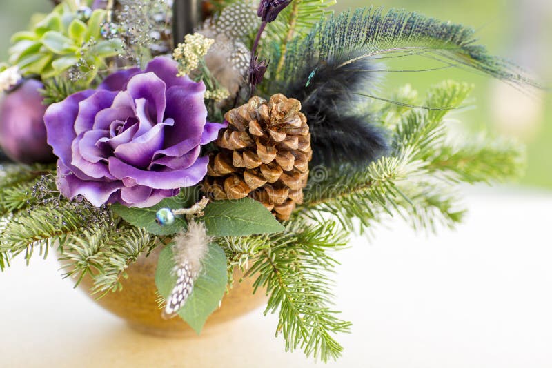 Bouquet has Christmas tree branches and artificial flowers.