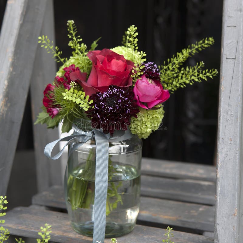 Bouquet of Hydrangea, Carnations and Hydrangeas in a Glass Jar on the