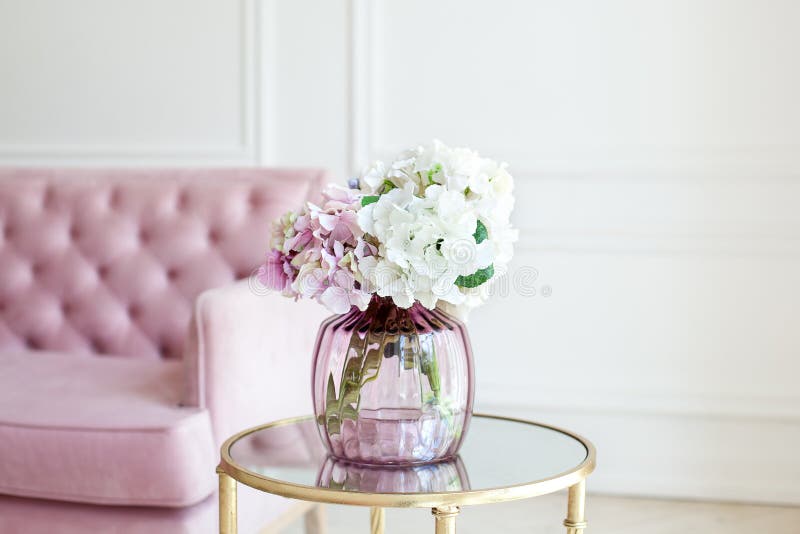 Bouquet of pastel hydrangeas in glass vase. Flowers in a vase at home. beautiful bouquet of hydrangeas is in a vase on a table nea