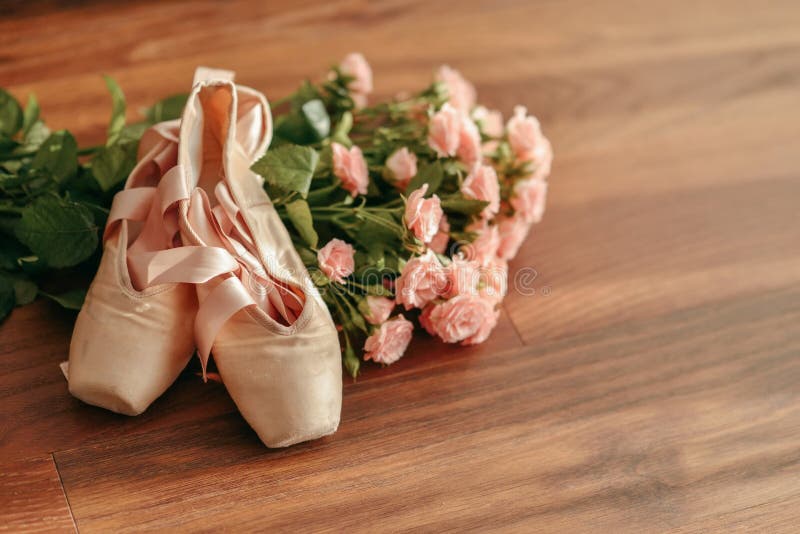 Bouquet of pink roses and pointe shoes