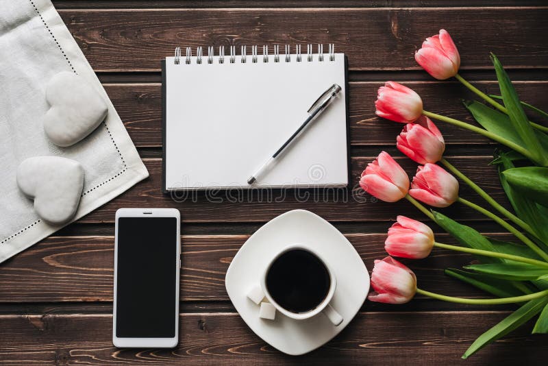 Bouquet of pink Tulip flowers with a Cup of coffee and sweet gingerbread for the morning Breakfast