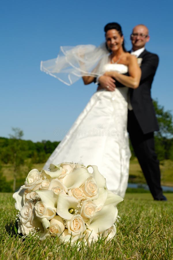 Bouquet and wedding couple