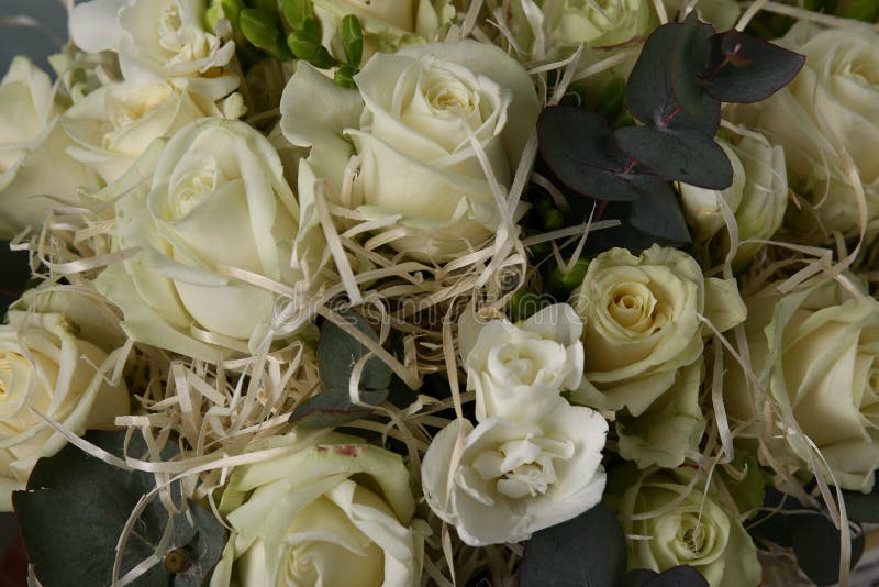 Bouquet with white roses and decorative straw stock photos