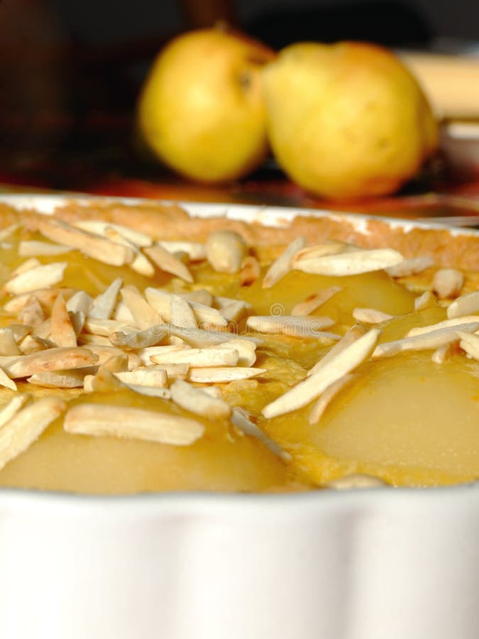 Close-up of a homemade tart Bourdaloue with pears, almond cream and vanilla custard and some ingredients besides. Close-up of a homemade tart Bourdaloue with pears, almond cream and vanilla custard and some ingredients besides