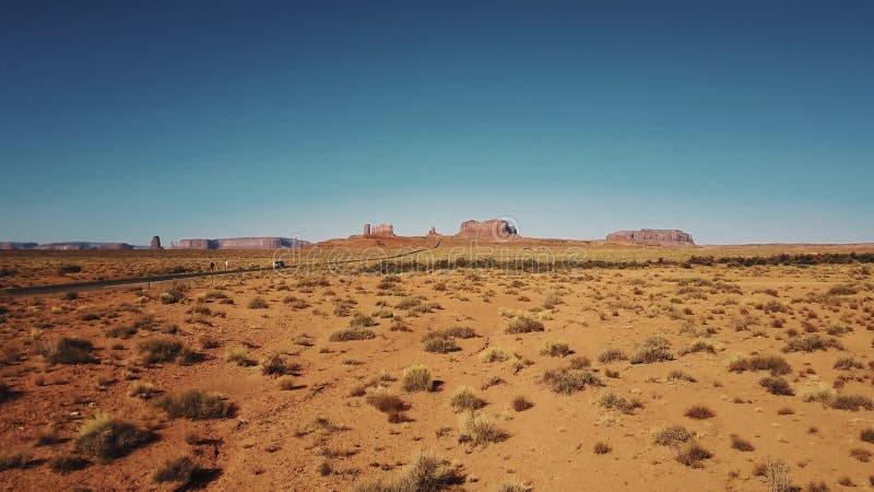 Bourdon volant bas au-dessus du désert américain sec de grès près de la vallée de monuments en Arizona et en Utah, ciel bleu enso