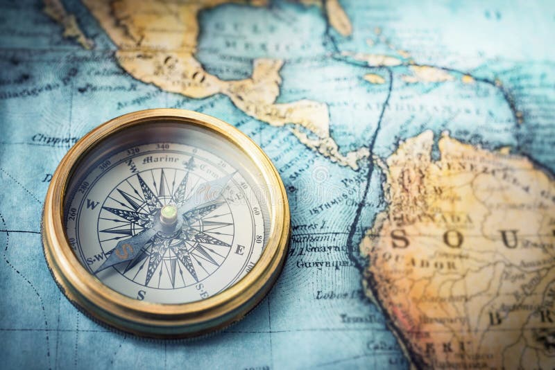 Magnetic compass on world map. Travel, geography, navigation, tourism and exploration concept background. Macro photo. Very shallow focus. Magnetic compass on world map. Travel, geography, navigation, tourism and exploration concept background. Macro photo. Very shallow focus.
