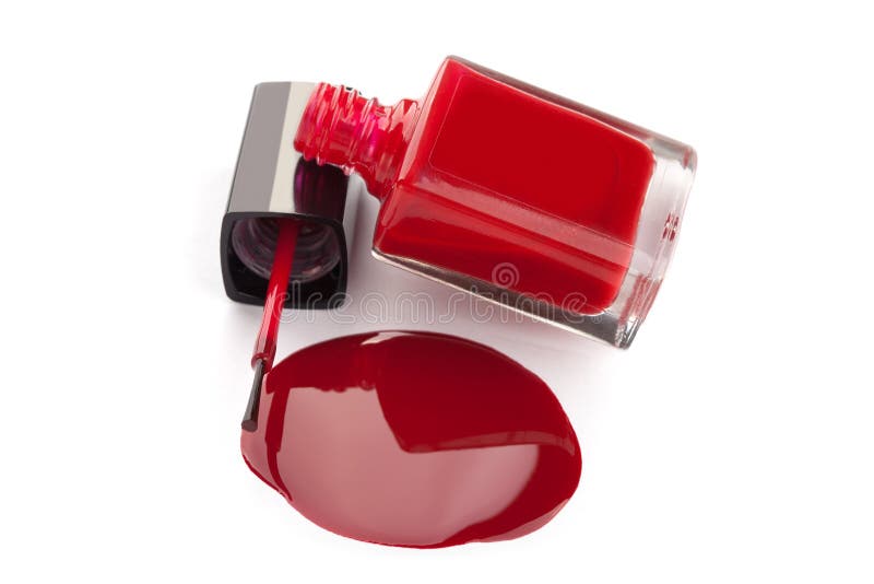 Red nail polish bottle with spilled varnish isolated on white background. Red nail polish bottle with spilled varnish isolated on white background