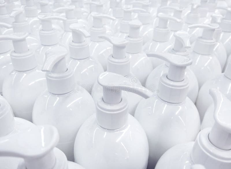 Bouteilles non étiquetées blanches de savon liquide dans le supermarché, répétant la PA images stock Bouteilles non étiquetées blanches de savon liquide dans le supermarché, répétant la PA images stock