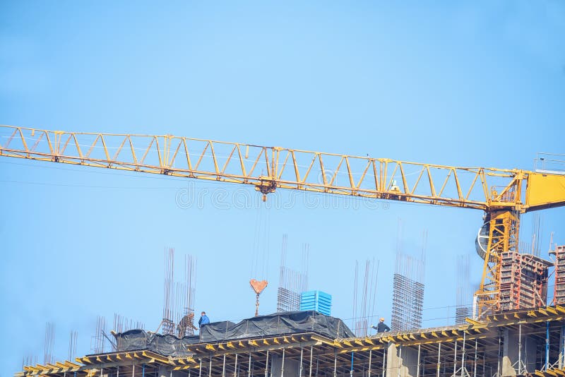 Construction of a multi-storey building. Tap. concrete blocks of the last floors and workers on the roof. Construction of a multi-storey building. Tap. concrete blocks of the last floors and workers on the roof.