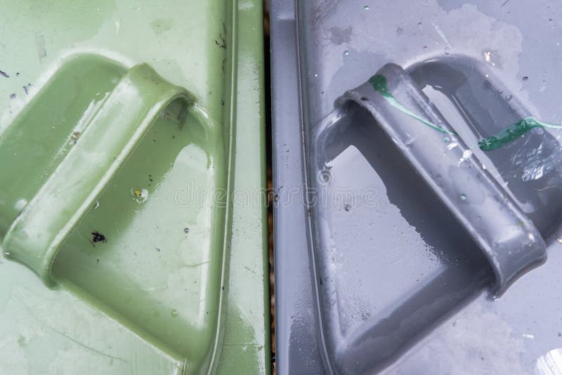 Top down view of household blue and green waste bins used by a typical household. Shown after a heavy downpour. Top down view of household blue and green waste bins used by a typical household. Shown after a heavy downpour.