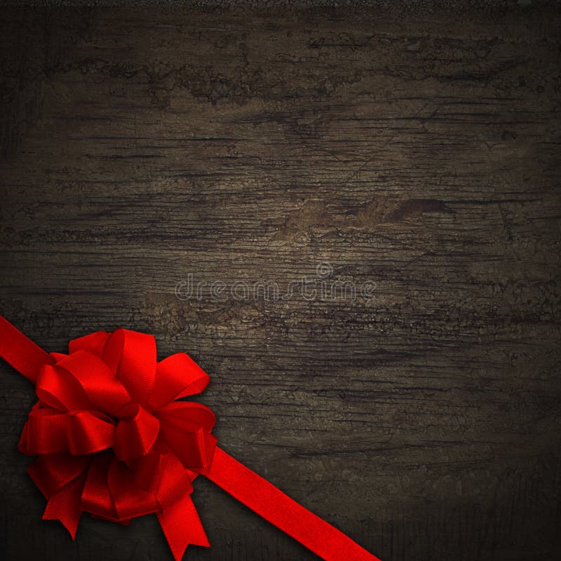 Red bow on black wall wood texture background