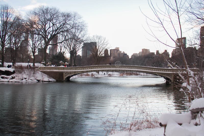 Bow bridge over the lake with snow in winter before sunset, Central Park royalty free stock photography Bow bridge over the lake with snow in winter before sunset, Central Park royalty free stock photography