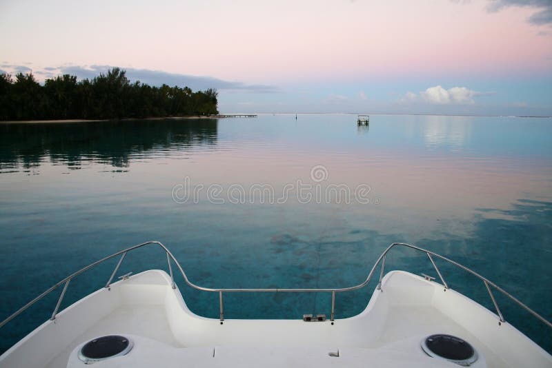 Bow of catamaran boat at sunset