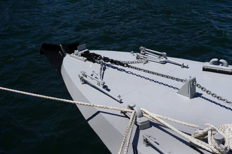 Bow of a grey warship against the blue sea with anchor at the bow. copy space, selective focus, narrow depth of field. Bow of a grey warship against the blue stock photos Bow of a grey warship against the blue sea with anchor at the bow. copy space, selective focus, narrow depth of field. Bow of a grey warship against the blue stock photos