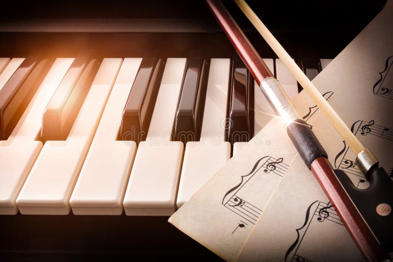 Bow with sheet music on piano keys front royalty free stock images