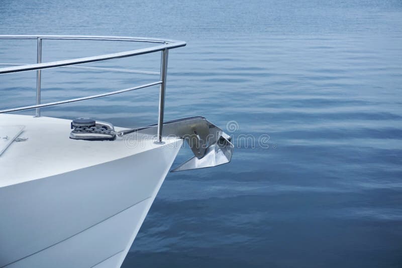 Bow of a white sailing yacht against the blue sea with anchor at the bow. copy space, selective focus, narrow depth of field. royalty free stock photo Bow of a white sailing yacht against the blue sea with anchor at the bow. copy space, selective focus, narrow depth of field. royalty free stock photo