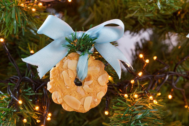 Bow with wreath cookie in Christmas tree with lights