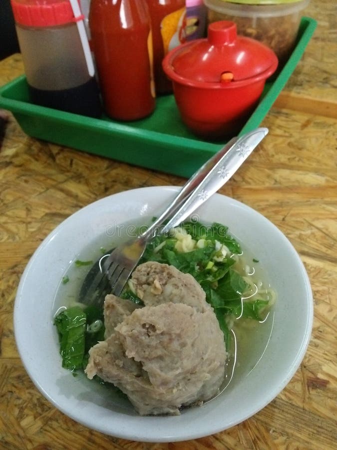 A bowl of Bakso or Indonesian beef meatball with tendon. It is popular street food in Indonesia. Usually it served with yellow noodles and rice vermicelli. A bowl of Bakso or Indonesian beef meatball with tendon. It is popular street food in Indonesia. Usually it served with yellow noodles and rice vermicelli.