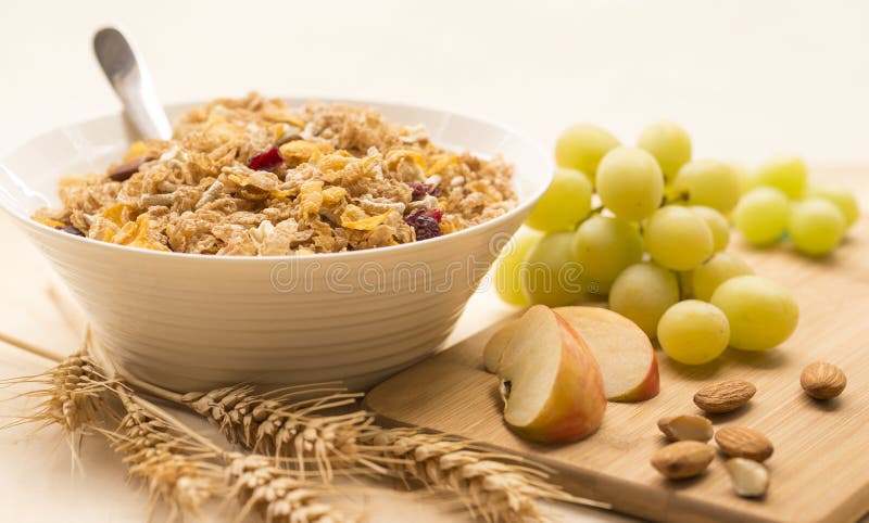 Bowl of Breakfast Cereal, Fresh Fruit and Wheat Stalks.