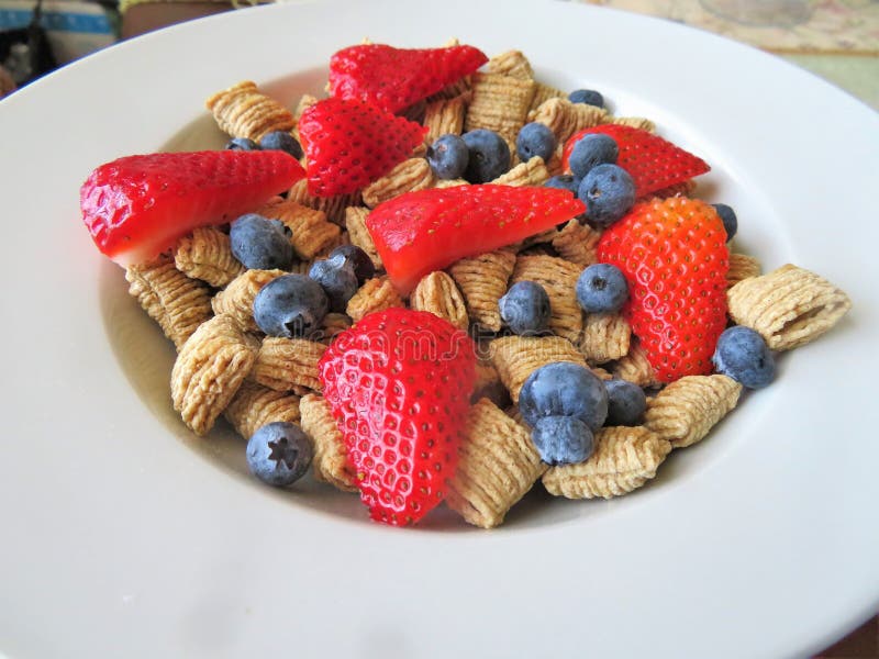Bowl of Cereal with Fresh Blueberries and Strawberries for a Nutritional Breakfast Stock Photo