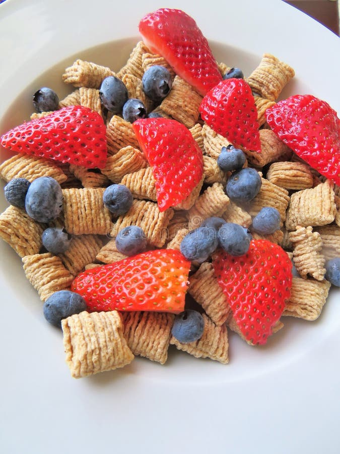 Bowl of Cereal with Fresh Blueberries and Strawberries for a Nutritional Breakfast Stock Image