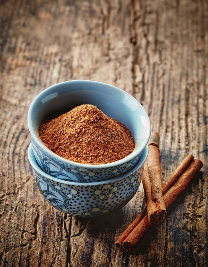 Bowl of cinnamon powder stock photo. Image of cooking 49643438