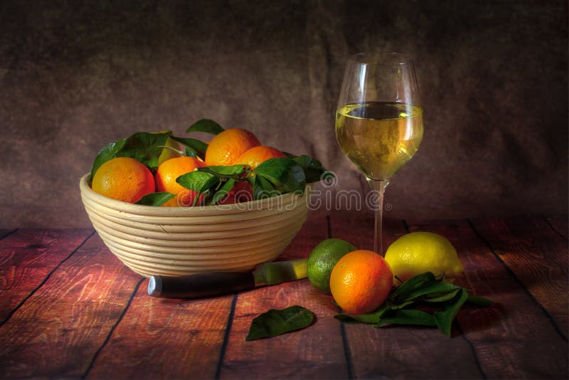 A bowl of citrus fruit and wine