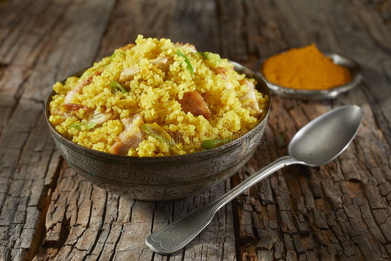 Bowl of couscous and quinoa colored with saffron stock image