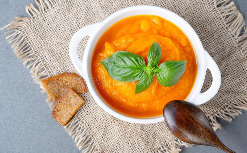 Bowl of delicious autumn pumpkin soup with rye croutons