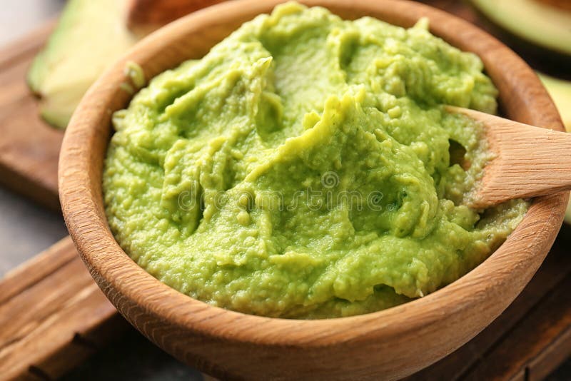 Bowl with delicious guacamole on board, closeup royalty free stock photo
