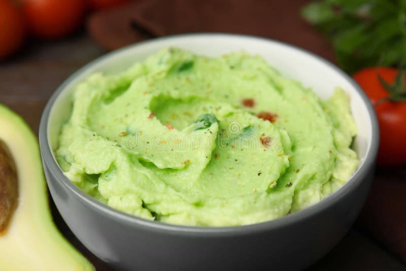 Bowl of delicious guacamole on table royalty free stock photos