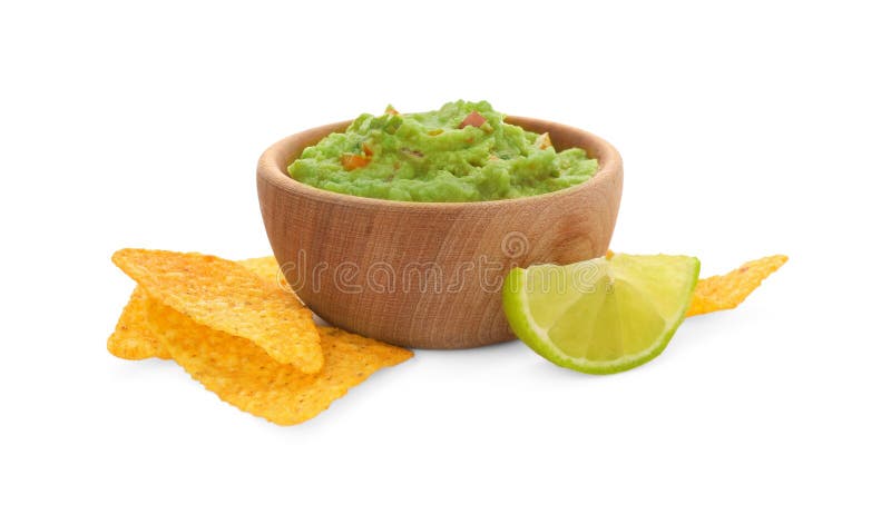 Bowl of delicious guacamole with tortilla chips and lime isolated on white royalty free stock photos