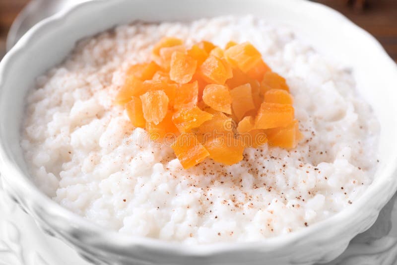 Bowl with Delicious Rice Pudding and Dried Apricot, Closeup Stock Image