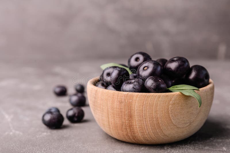 Bowl of Fresh Acai Berries on Grey Stone Table, Closeup. Stock Image