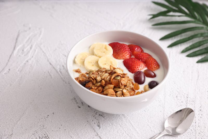 Bowl of Granola Cereal with Yogurt and Berries Isolated on White