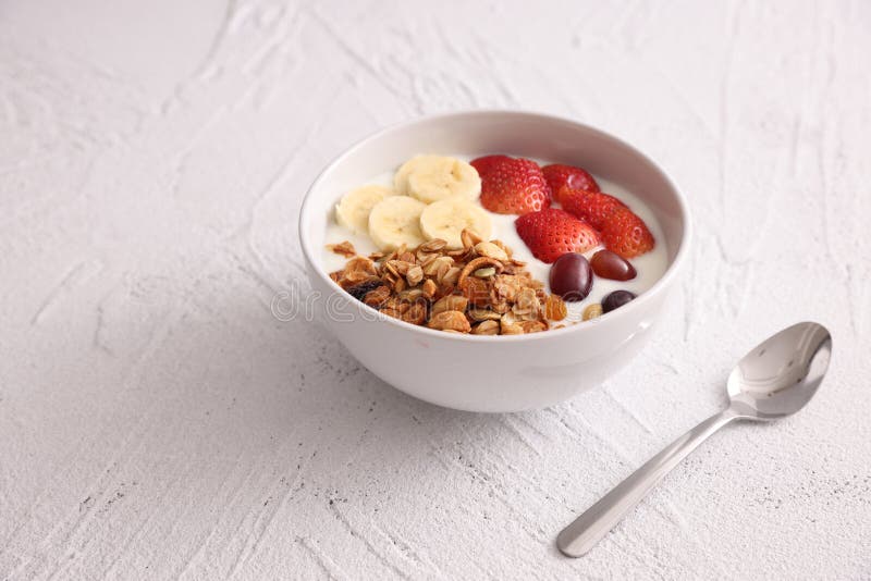 Bowl of Granola Cereal with Yogurt and Berries Isolated on White