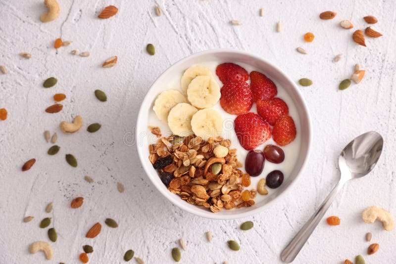 Bowl of Granola Cereal with Yogurt and Berries Isolated on White