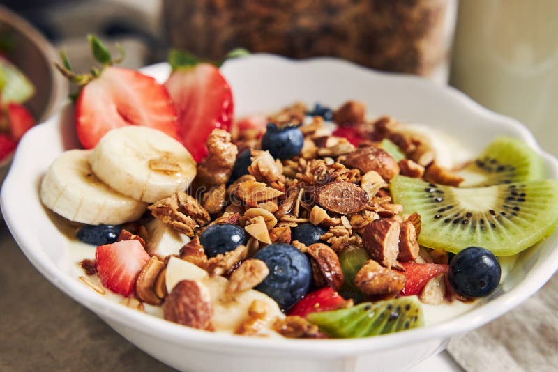 Bowl of Granola with Yogurt, Fruits and Berries on a White Surface ...