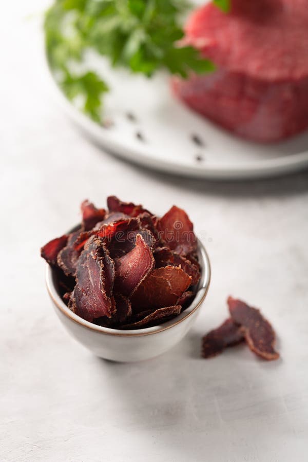Bowl with Jerky Meat and Raw Beef on Gray Concrete Background Stock Photo Image of macro