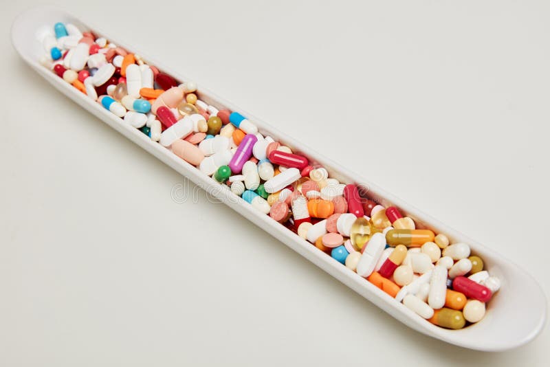 Bowl with a lot of colorful medicines drugs and tablets. Bowl with lots of colorful medicines drugs and tablets and pills stock photo Bowl with a lot of colorful medicines drugs and tablets. Bowl with lots of colorful medicines drugs and tablets and pills stock photo