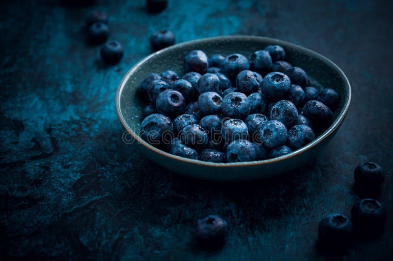 Bowl of organic and fresh blueberries on kitchen table royalty free stock images