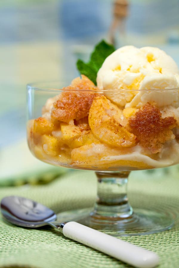 A Bowl Of Peach Cobbler With Vanilla Ice Cream Against A Colorful Background