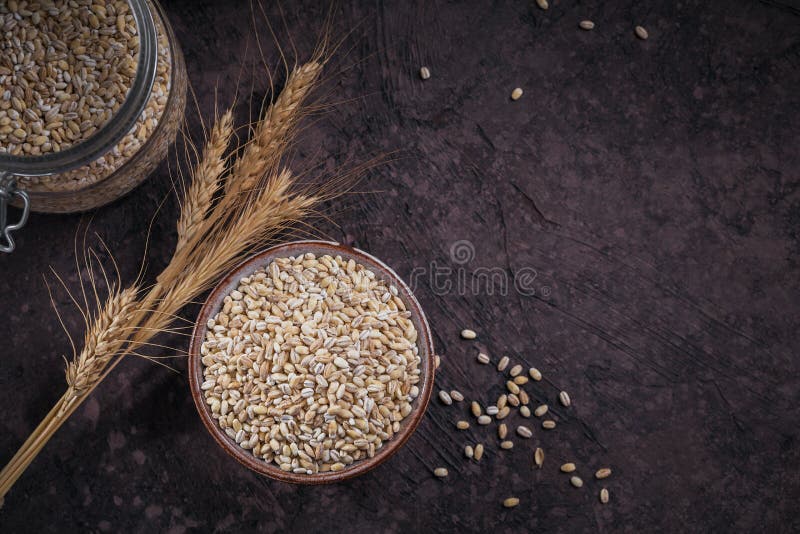 Bowl of raw dried broken pearl barley cereal grain
