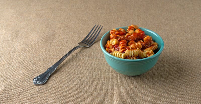 Bowl of Rotini in a Sausage and Pasta Sauce and a Fork Stock Image