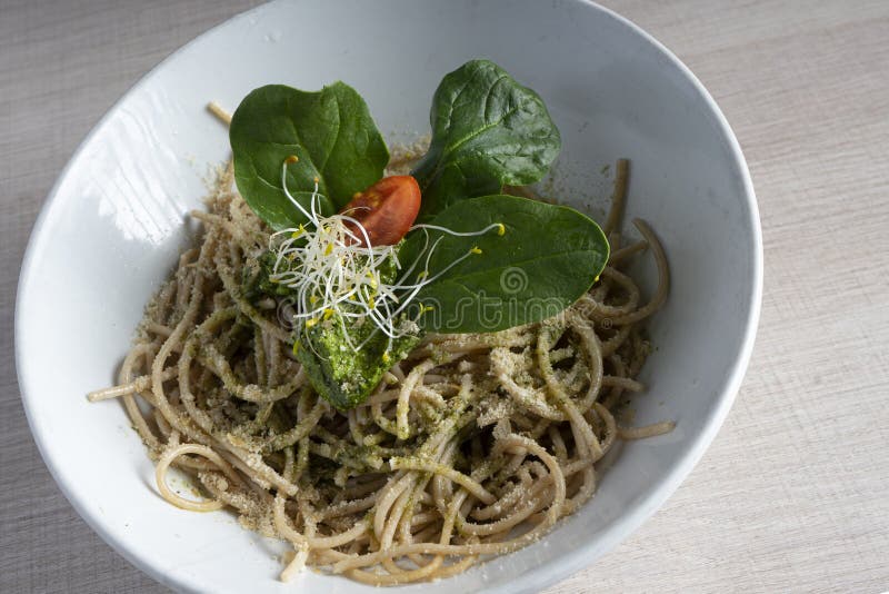Bowl of Spaghetti Pesto with Basil Leaves and Bean Sprouts Stock Image