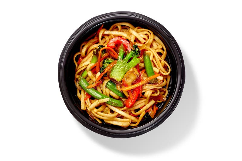 Bowl of spicy stir fried udon noodles with broccoli, bell peppers, green beans and mushrooms