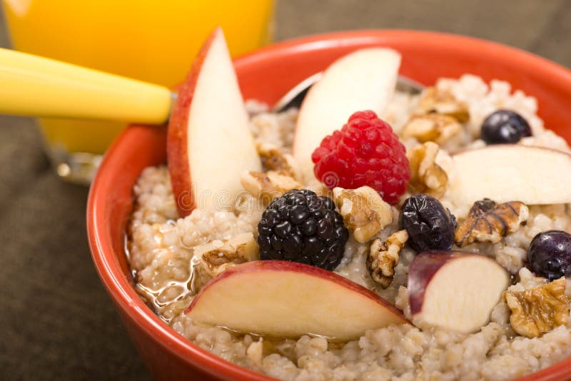 Bowl of steel cut oats served with fresh fruit and honey