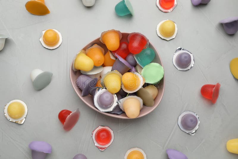 Bowl with Tasty Bright Jelly Cups on Light Table, Flat Lay Stock Image